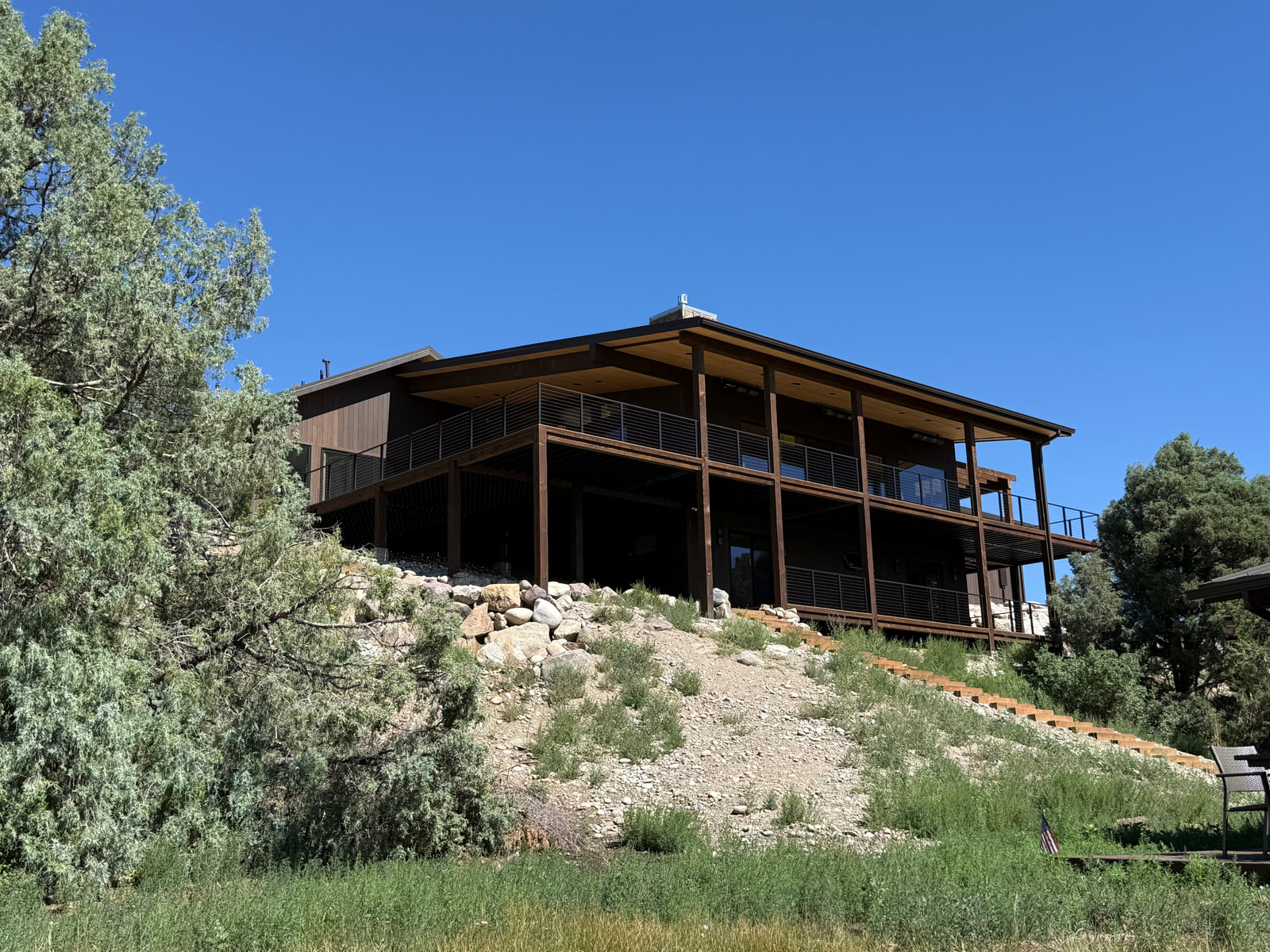 Low-profile walkout residence positioned on a hillside above the Arkansas River.