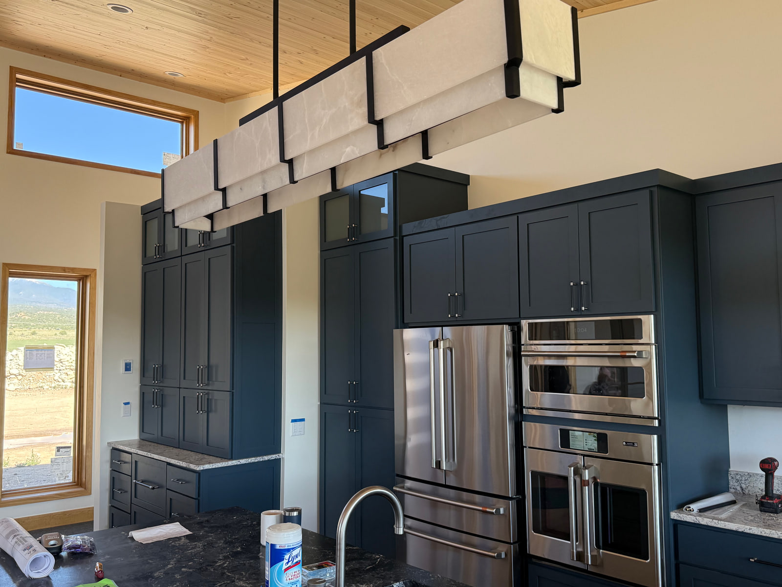 Kitchen cabinetry and lighting within the open main-floor living area.